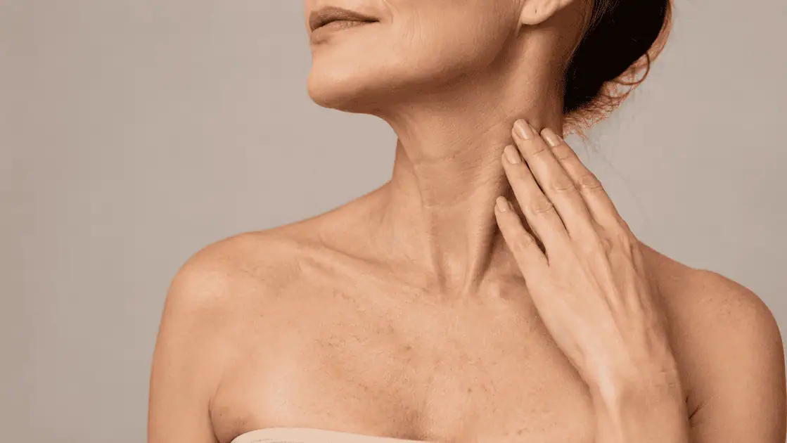 Neck and chest skin showing visible signs of aging, including fine lines, texture, and sun damage.