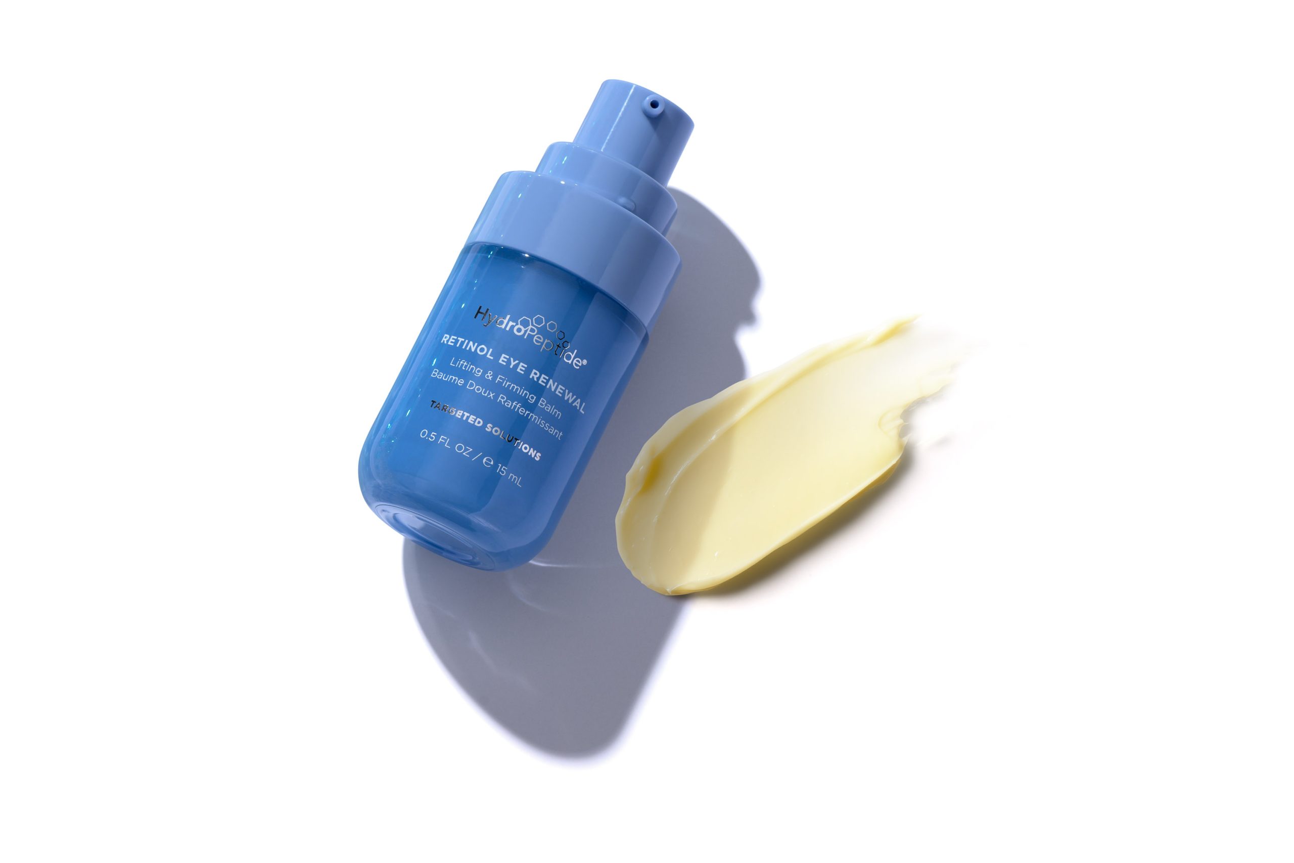 HydroPeptide Retinol Eye Renewal bottle next to a smear of pale yellow cream.