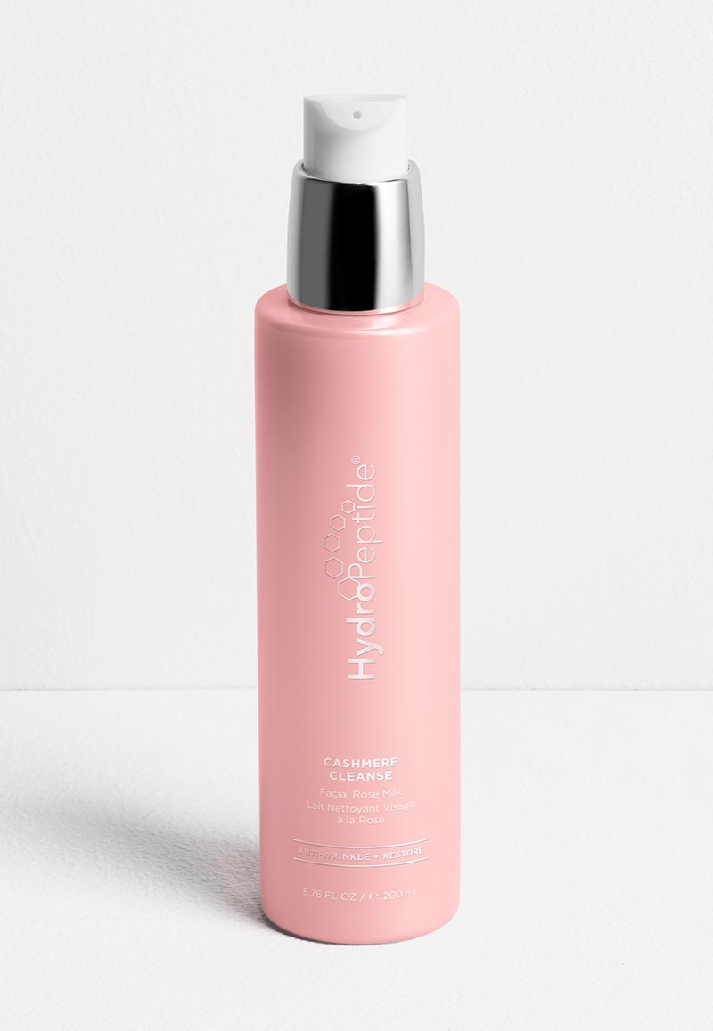 A light pink pump bottle of HydroPeptide Cashmere Cleanse Facial Rose Milk.