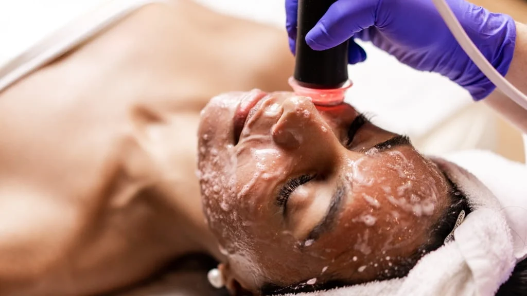 Woman receiving OxyGeneo facial treatment